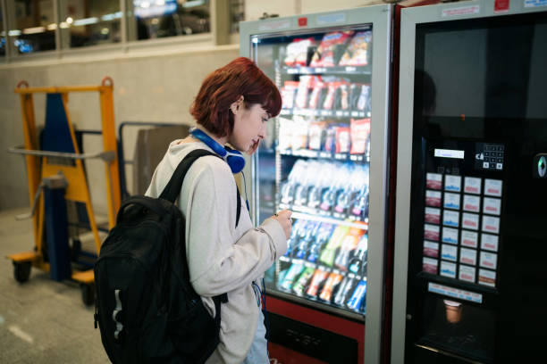 Side-view-of-a-young-happy-Caucasian-woman-looking-at-a-vending-machine_1762760444